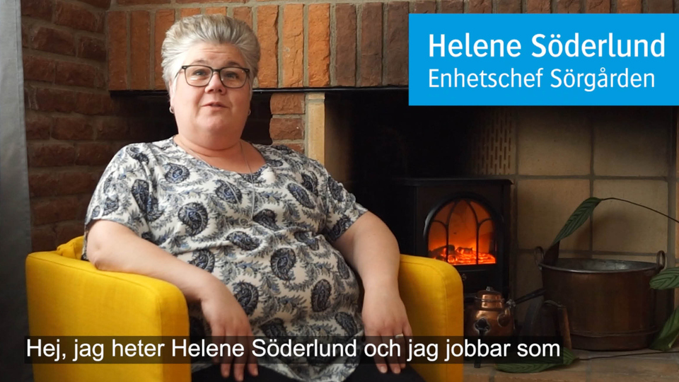 Helene Söderlund, enhetschef på Sörgården sitter i en fåtölj framför en öppen spis